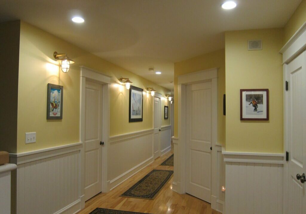 Bright Yellow Hallway with White Trim Interior Painting Yellow hallway interior with white trim and doors painted by IAP Inc. for Merlino Builders in Mashpee MA.