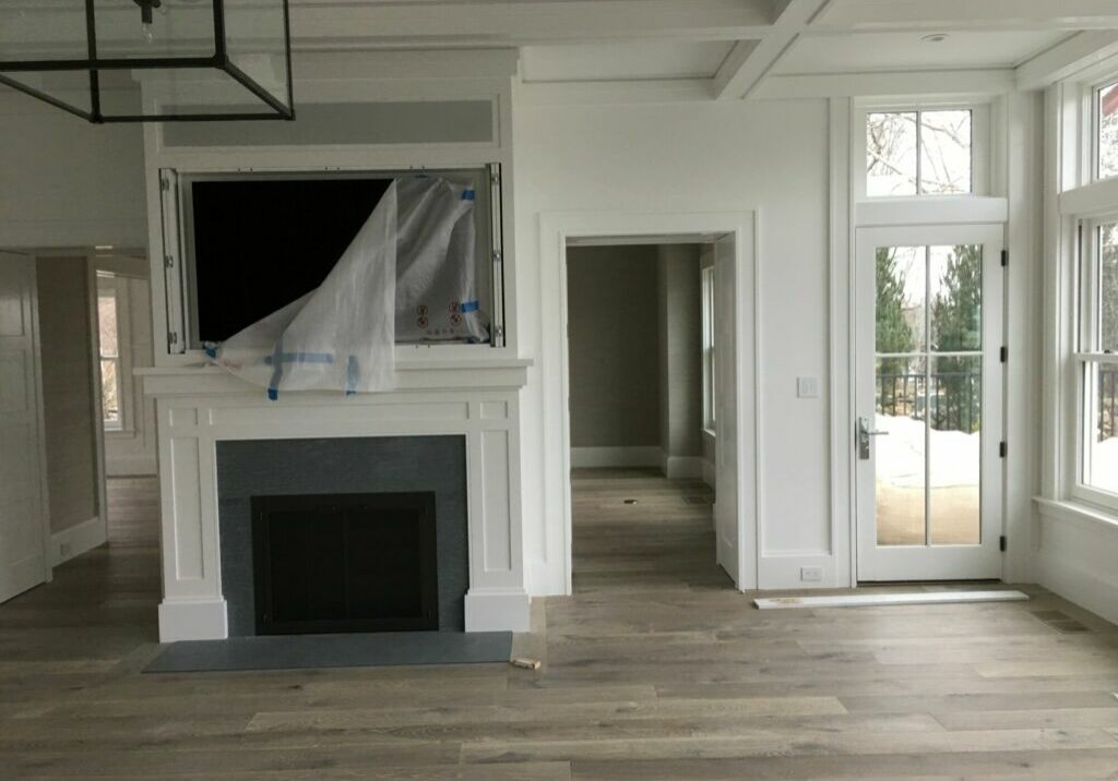 Interior Painting for Open Living Room Area Open interior with bookshelf, ceiling beams, pocket dining doors, and poolside views painted by IAP Inc. for Wellen Construction in Woods Hole, Falmouth MA.